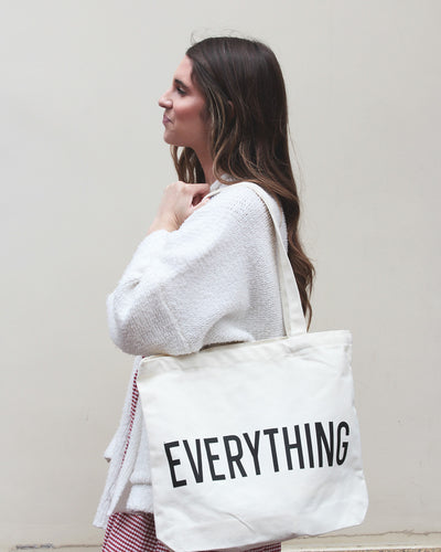 White bag with Black writing which states, "EVERYTHING"