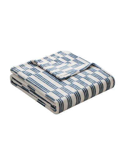 Folded blue and white striped blanket on a white background
