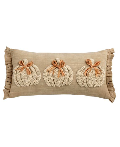 Decorative pillow with three pumpkin patterns on a beige background