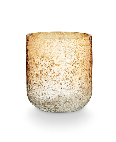 Glass candle holder with textured surface on a white background