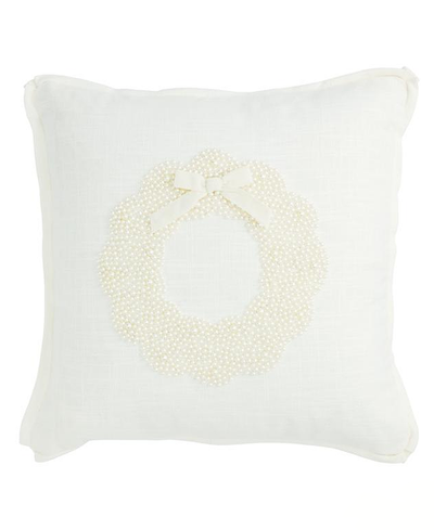 White pillow with a decorative wreath made of pearls on a white background