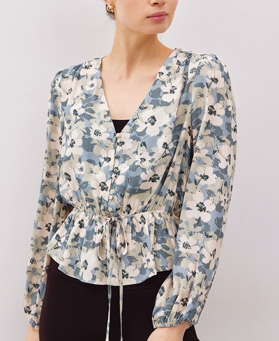 Woman wearing a floral blouse with a plain background