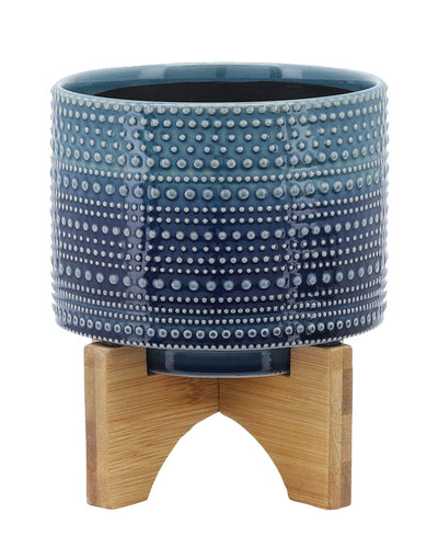 blue pot on wood stand