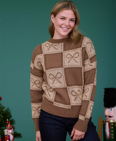 Woman wearing a brown and beige patterned sweater against a teal background with Christmas decorations.