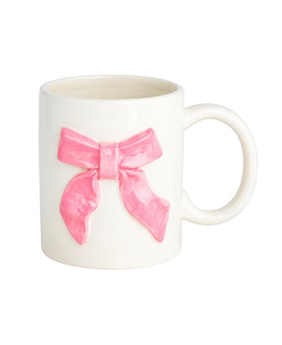 White mug with a pink bow design on a white background