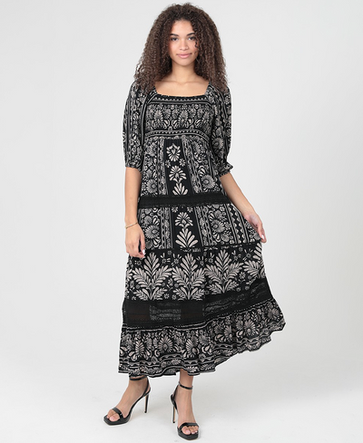 Woman wearing a black and white patterned dress on a white background