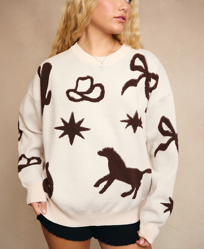 White sweater with brown patterns of a horse, star, and cowboy hat worn by a person.