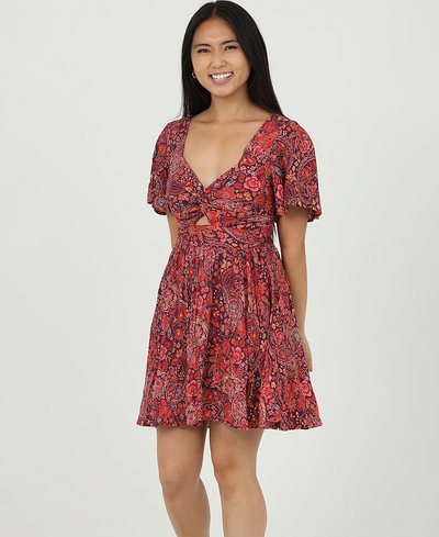 Woman wearing a red floral dress on a white background