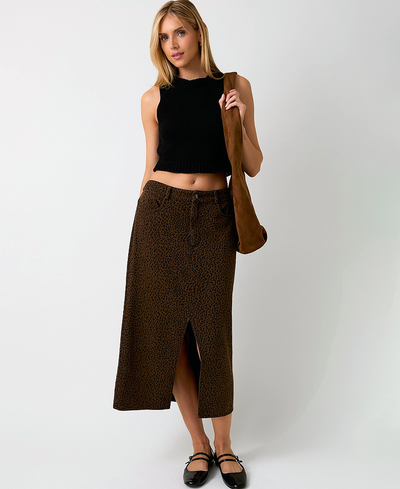 Woman wearing a black top and brown leopard skirt with a white background
