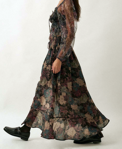 Long, floral-patterned skirt worn by a person on a white background