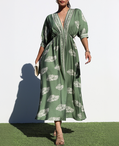 Woman wearing a green dress with white floral patterns against a white background