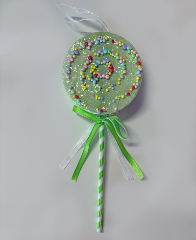 Decorative lollipop with colorful sprinkles on a white background