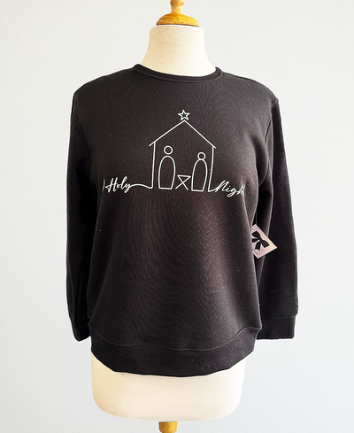 Black sweatshirt with white nativity scene design on a mannequin against a white background