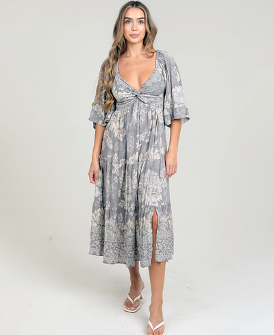 Woman wearing a gray floral dress on a white background