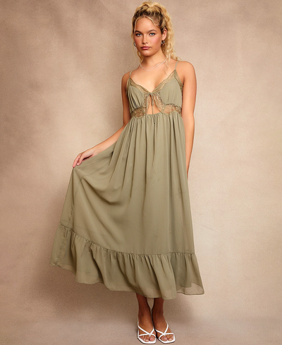 Woman wearing a green dress against a beige background