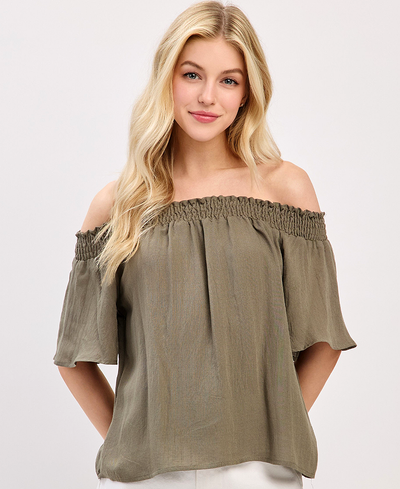 Woman wearing an off-shoulder olive green top on a white background