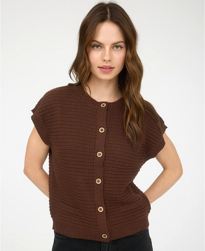Woman wearing a brown knitted cardigan with buttons on a white background