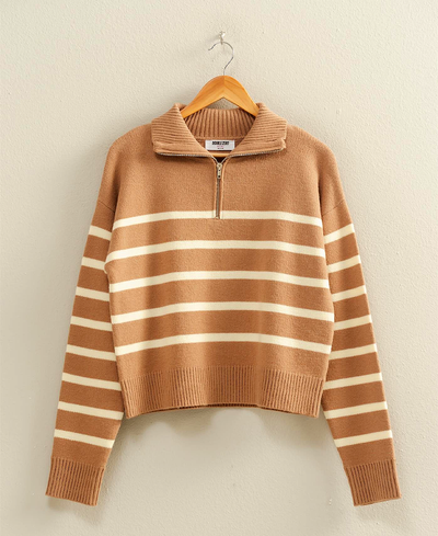 Brown and white striped sweater on a hanger against a beige background