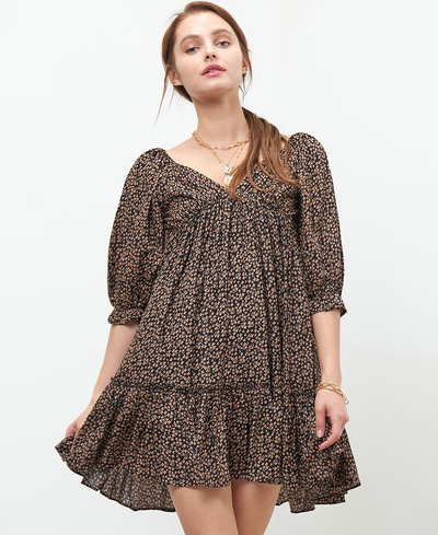 Woman wearing a black floral dress on a white background