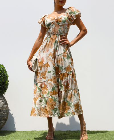 Woman wearing a floral dress against a white wall