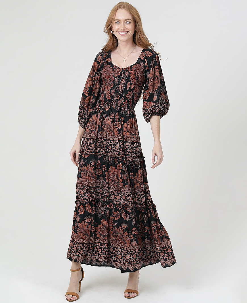 Woman wearing a patterned dress on a white background