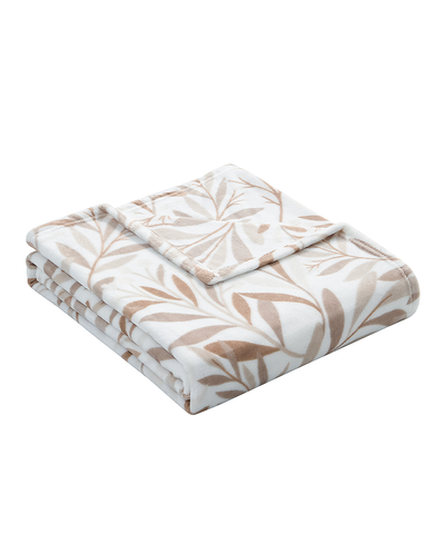 Folded blanket with leaf pattern on a white background