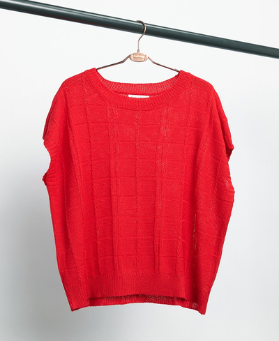 Red sweater on a hanger against a white background