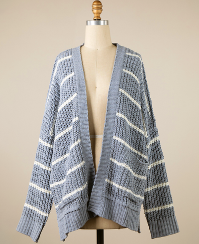 Blue grey and white striped cardigan on a mannequin against a beige background