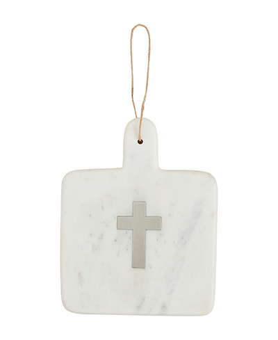 Marble cutting board with a cross design and string for hanging on a white background
