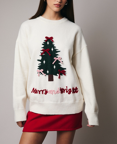 White sweater with Christmas tree design and 'Merry and Bright' text on a gray background