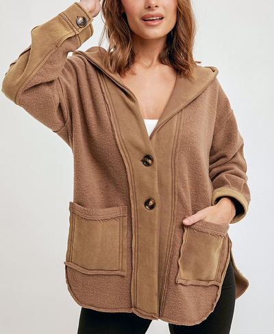 Woman wearing a brown hooded jacket on a white background