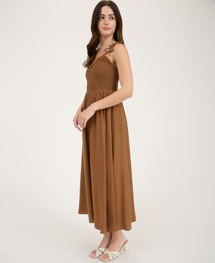 Woman wearing a brown dress on a white background