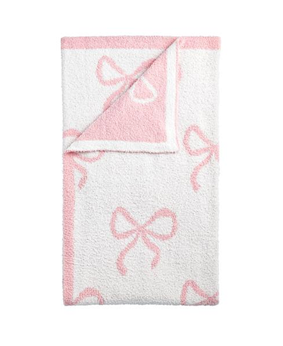 White blanket with pink bows on a white background