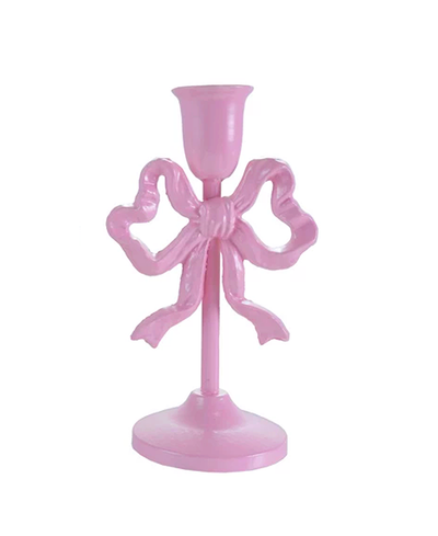 Pink candle holder with bow design on a white background