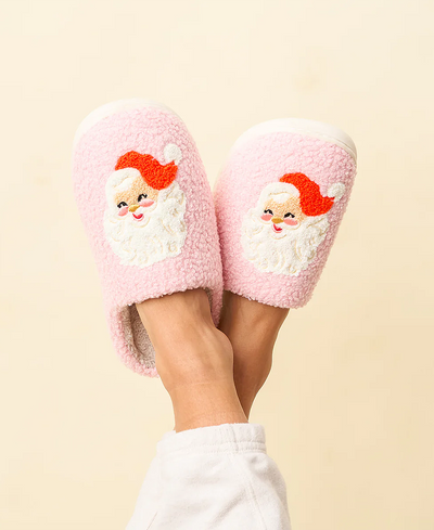 Pink slippers with Santa Claus design on a beige background