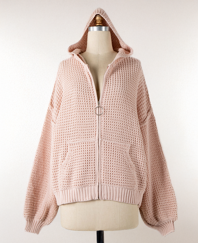 Pink knitted hoodie on a mannequin against a white background