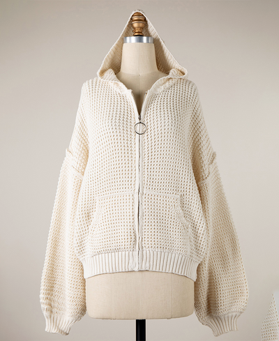 Cream knitted hoodie on a mannequin against a neutral background
