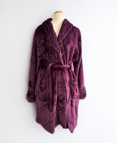 Purple robe on a mannequin against a white background
