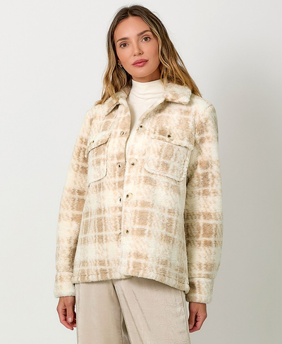 Woman wearing a plaid jacket on a white background