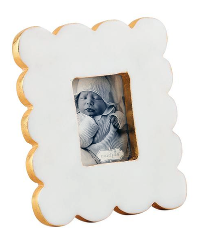 White cloud-shaped photo frame with a baby picture inside on a white background