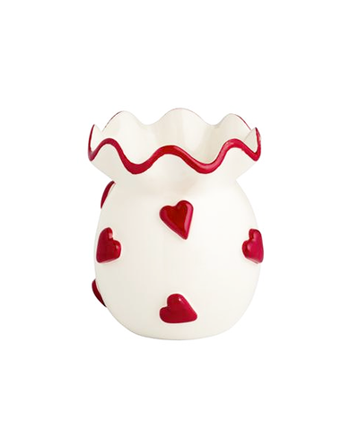 White vase with red ruffled rim and heart patterns on a white background