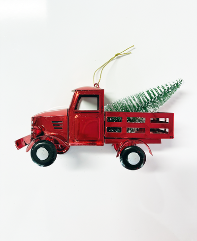 Red truck Christmas ornament with a tree on a white background