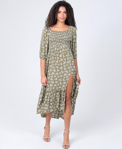 Woman wearing a green floral dress on a white background
