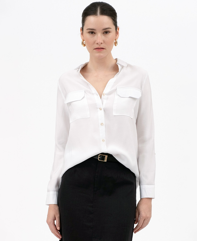 Woman wearing a white blouse and black pants on a white background