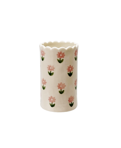White ceramic vase with floral pattern on a white background