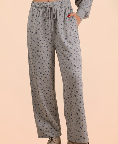 Floral patterned gray sweats on a beige background