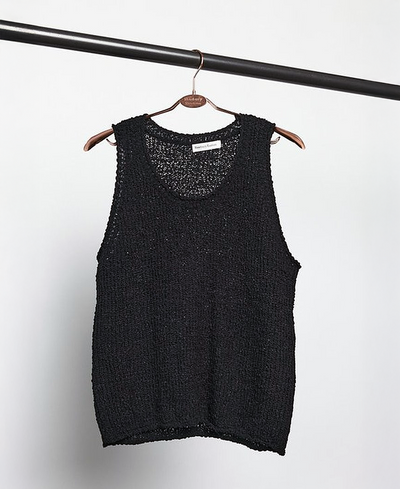 Black textured tank top on a hanger against a white background