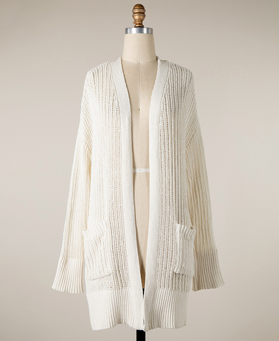 Knitted cardigan on a mannequin against a plain background