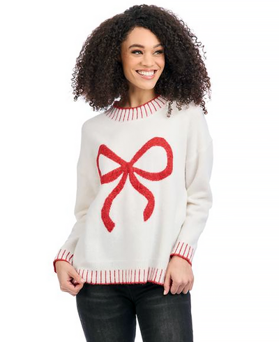 Woman wearing a white sweater with a red bow design on a white background
