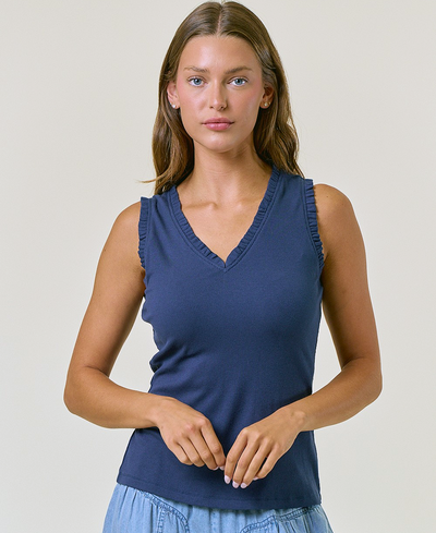 Woman wearing a blue sleeveless top against a plain background